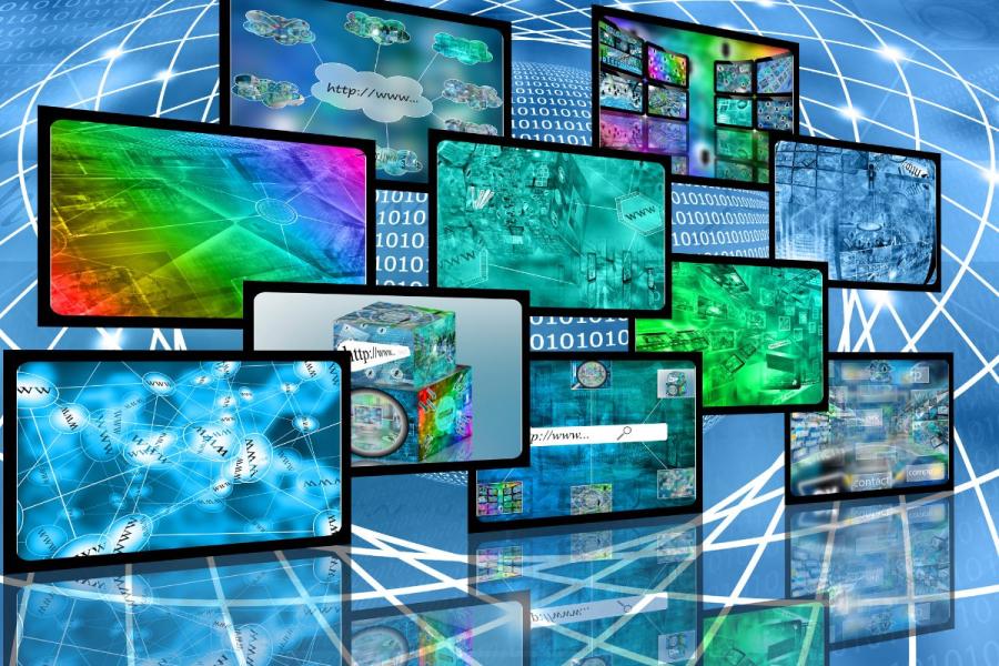 Several computer screens with web content.